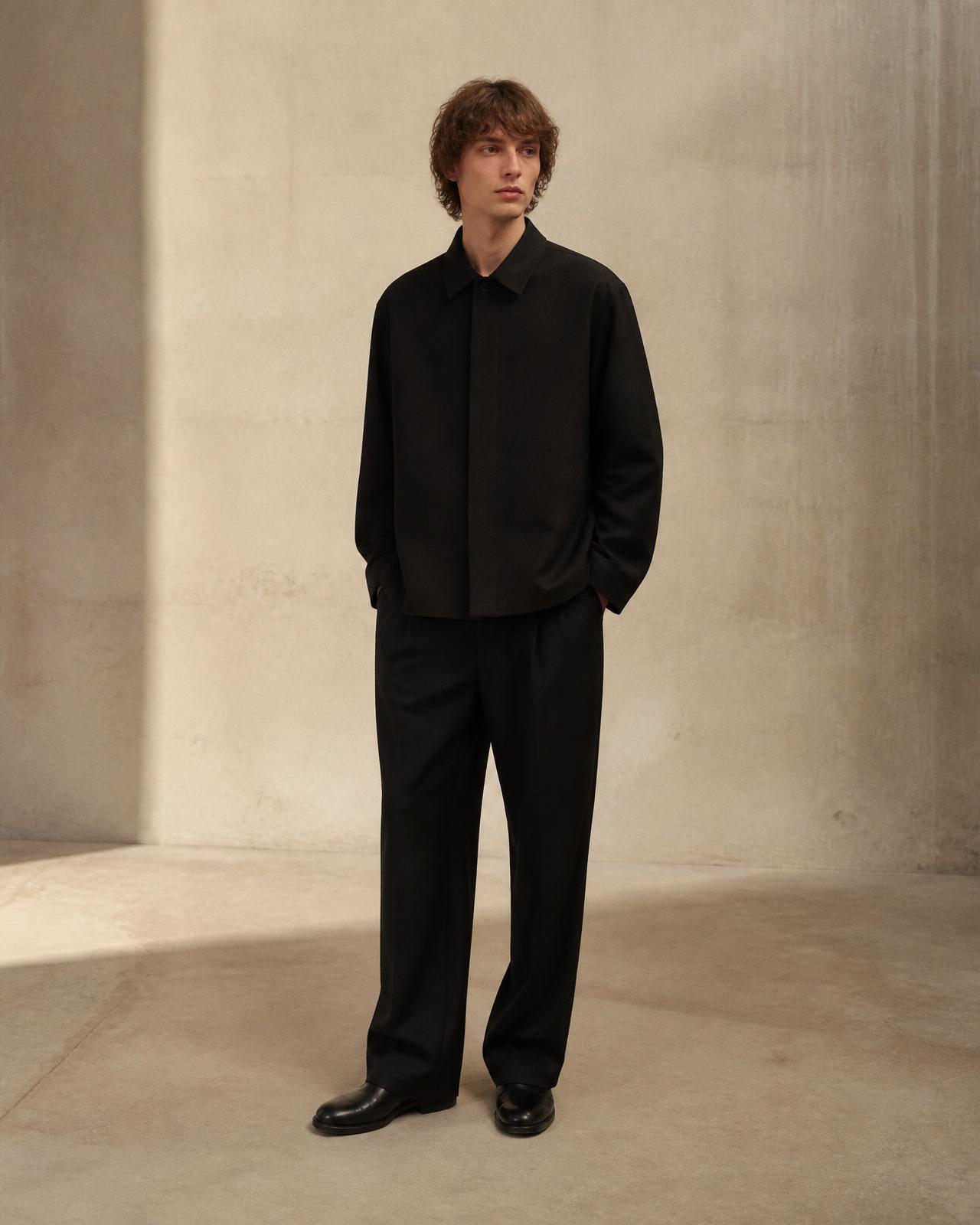 Model wearing The 01 Jacket, a minimalist black overshirt by Atelier 127